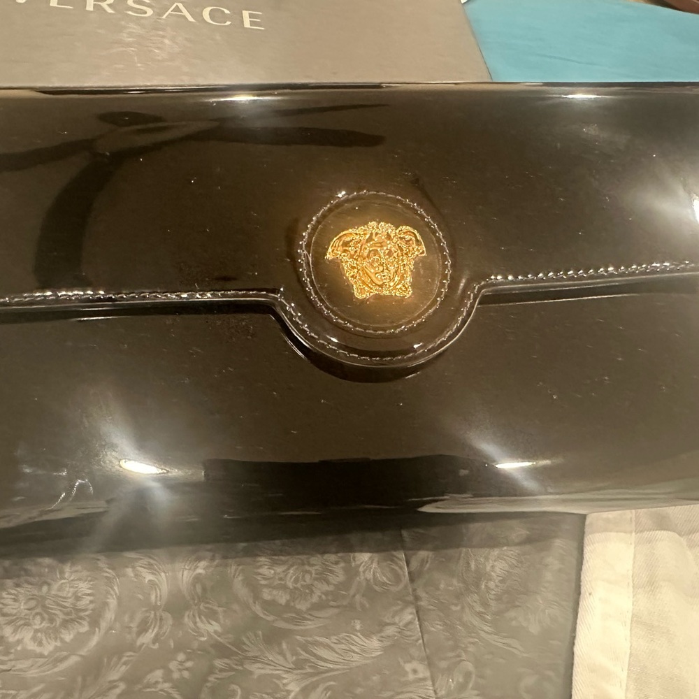 Versace Patent Leather clutch comes with sleeve,tags,box 12”x6”.